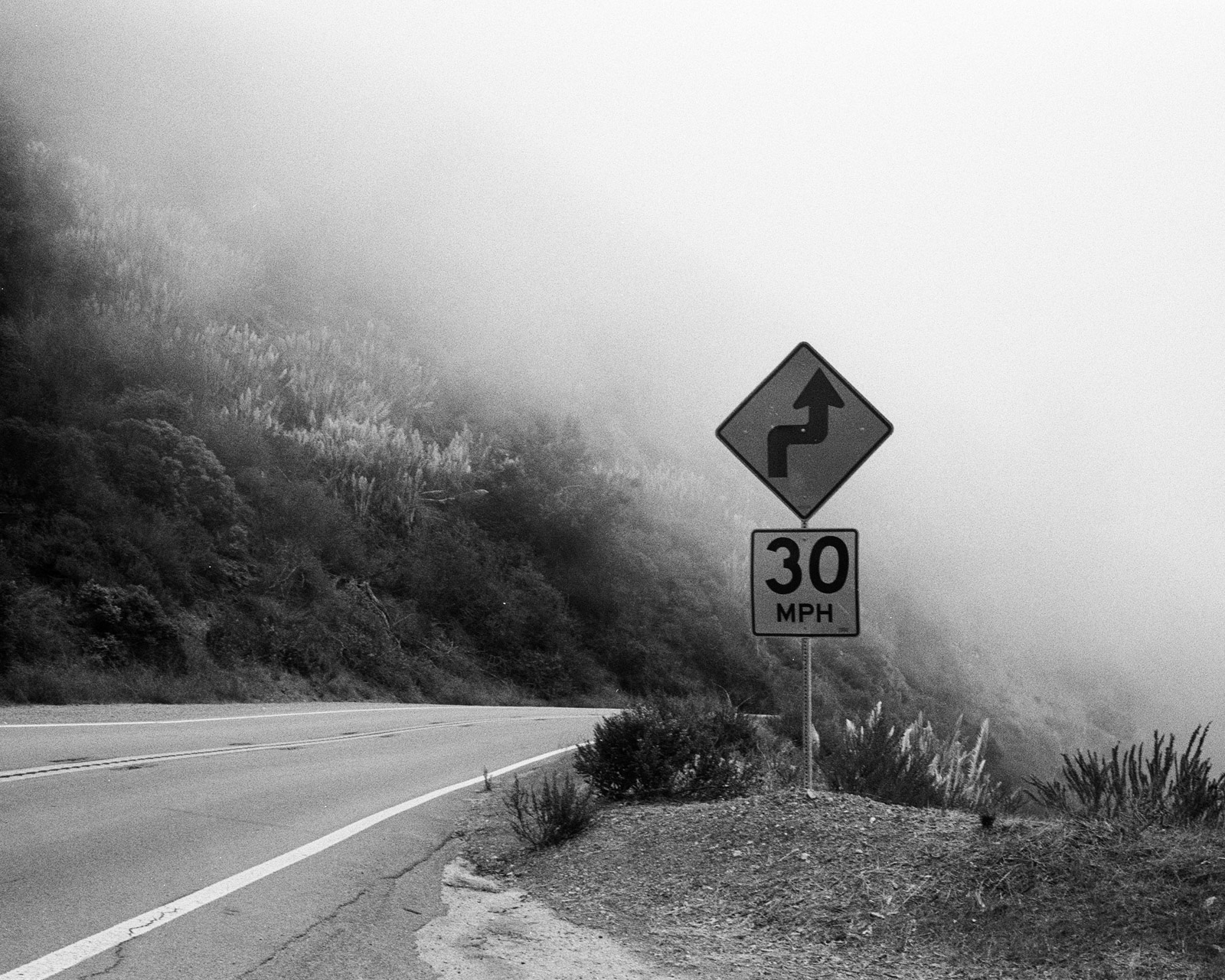 30mph sign through a road curve and fog